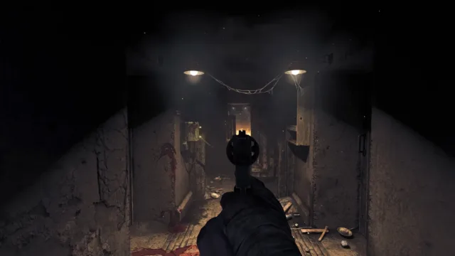 Amnesia: The Bunker — a weapon aimed down a dark bunker corridor