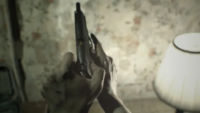 Resident Evil 7 Biohazard — a handgun held in a close first-person view
