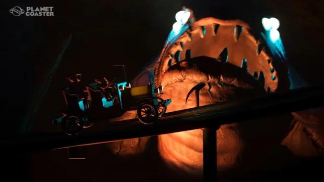 Planet Coaster — a coaster passing a firelit themed structure