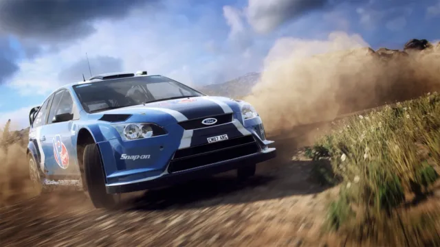DiRT Rally 2.0 — a blue rally car crossing a dusty stage