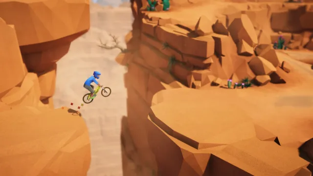 Lonely Mountains: Downhill — a cyclist descending through orange rock