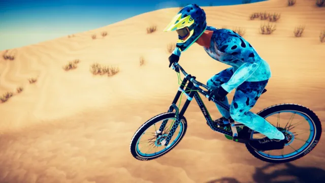 Descenders — PC screenshot: A cyclist approaching a sandy jump