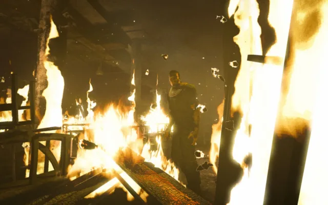 Outlast — PC screenshot: A burning room viewed through a doorway